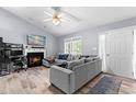 Comfortable living room featuring a fireplace, gray sofa, and ample natural light at 601 Southampton Dr, Knightdale, NC 27545