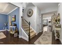 Spacious foyer with hardwood floors, staircase, and stylish decor at 6521 Sunset Manor Dr, Wake Forest, NC 27587