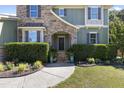 Charming home front entrance featuring stone archway, well maintained shrubs and flowering plants at 6521 Sunset Manor Dr, Wake Forest, NC 27587