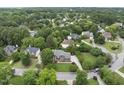 Beautiful aerial view showcases a large, well-maintained home nestled among mature trees in a quiet neighborhood at 704 Walcott Way, Cary, NC 27519