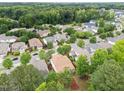 Expansive aerial view of a residential neighborhood nestled among lush green trees and landscaping at 7768 Berry Crest Ave, Raleigh, NC 27617