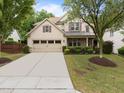 Attractive home with a spacious driveway, two-car garage, manicured lawn, and beautiful landscaping at 7768 Berry Crest Ave, Raleigh, NC 27617