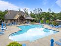Inviting community pool surrounded by lounge chairs, umbrellas, and a clubhouse, perfect for relaxation at 7768 Berry Crest Ave, Raleigh, NC 27617