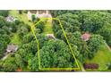 Aerial view showcasing the property's boundaries amidst lush greenery and a serene pond at 7918 Dairy Ridge Rd, Mebane, NC 27302