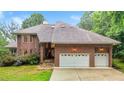 Stunning brick home showcasing a two-car garage and well-manicured landscaping at 7918 Dairy Ridge Rd, Mebane, NC 27302