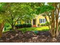 Charming yellow home with trees and shrubbery in a peaceful neighborhood at 8116 Owenston Ct, Raleigh, NC 27612