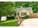 Inviting yellow home with well-maintained lawn and attractive landscaping at 8116 Owenston Ct, Raleigh, NC 27612