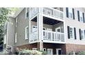 Multi-level building with balconies, brick accents, and black shutters at 923 Springfork Dr, Cary, NC 27513