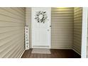 Charming front door with a decorative wreath, 'Welcome' sign and a patterned doormat at 923 Springfork Dr, Cary, NC 27513