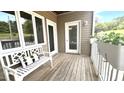 Cozy outdoor patio with a bench, decorative pillow, and potted plants at 923 Springfork Dr, Cary, NC 27513