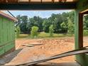 Construction site featuring an expansive nature view with a lake, captured from inside the garage at 1013 Coldspring Circle, Durham, NC 27705