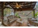 Cozy covered porch with wicker furniture, a ceiling fan, and a relaxing hammock, perfect for outdoor living at 103 Pony Express Cv, Louisburg, NC 27549