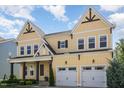 Charming two-story home with a well-manicured lawn, covered porch, and a convenient two-car garage at 1131 Lowland St, Apex, NC 27523