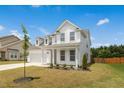 Lovely two-story home with a welcoming front porch and an attached two-car garage at 116 Hayfield Dr, Lillington, NC 27546