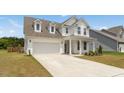 Beautiful two-story home with an attached two-car garage and well-maintained front lawn at 116 Hayfield Dr, Lillington, NC 27546