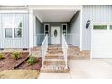 Inviting front porch with brick steps, white railings, and a decorative front door at 117 Knight Rd Rd, Broadway, NC 27505
