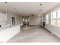 Spacious living area with wood floors, fireplace, and an open view to kitchen at 117 Knight Rd Rd, Broadway, NC 27505