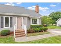 Welcoming front entry with brick steps, tidy landscaping, and covered entrance at 1228 Shakentown St, Knightdale, NC 27545