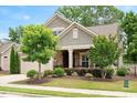 Inviting home exterior with stone accents, a cozy front porch, and a well-landscaped yard at 125 Greenway Landing Lndg, Chapel Hill, NC 27516