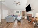 Spacious living room boasts hardwood floors, vaulted ceilings, fireplace, and large windows at 1426 Cedar Branch Ct, Wake Forest, NC 27587