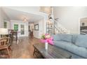 Open-concept living space with hardwood floors, stairs, and a view into the kitchen at 1426 Cedar Branch Ct, Wake Forest, NC 27587