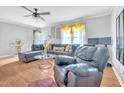 Comfortable living room with hardwood floors, a ceiling fan, and plenty of seating at 144 Shawnee Dr, Louisburg, NC 27549