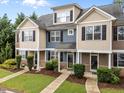 Inviting townhouse exterior featuring multiple units and manicured front lawns at 158 Pineland Cir, Raleigh, NC 27606