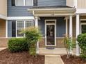 Close-up of front entrance, showcasing a well-maintained porch and landscaping at #158 at 158 Pineland Cir, Raleigh, NC 27606