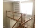 Hallway with wood railing, white spindles, and natural light highlighting the upstairs space at 158 Presidents Dr, Durham, NC 27704