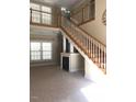 Bright living room featuring a fireplace and natural wood staircase and bright windows at 158 Presidents Dr, Durham, NC 27704