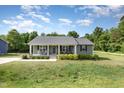 Beautiful single-story house with a cozy front porch and a well-kept lawn at 18 Hunter Fox Trl, Angier, NC 27501