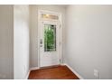 A bright entryway features a white door with glass and hardwood floors at 2001 October Dr, Durham, NC 27703