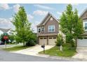 Charming two-story home featuring an attached two-car garage and well-maintained landscaping at 2001 October Dr, Durham, NC 27703