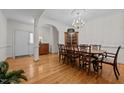 Elegant dining room featuring hardwood floors, a decorative chandelier, and archways at 2014 Muirfield Ct, Elon, NC 27244