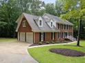 A spacious brick home with a two-car garage, well-kept landscaping, and a welcoming driveway and walkway at 221 Jansmith Ln, Raleigh, NC 27615
