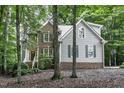 Beautiful two-story house with brick and siding facade, surrounded by mature trees for added privacy and charm at 2325 Old Oak Pl, Hillsborough, NC 27278