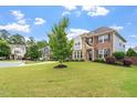 Beautiful two story home with a well manicured lawn, stone and brick exterior, and nice curb appeal at 2333 Lantern Walk Ln, Wake Forest, NC 27587