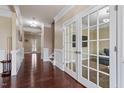 Elegant foyer features hardwood floors, crown molding and an office area with french doors at 2333 Lantern Walk Ln, Wake Forest, NC 27587
