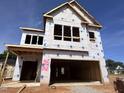 Exterior view of a two-story home under construction, framed, and wrapped, showcasing architectural details at 252 Meadowbark Bnd # 46, Garner, NC 27529