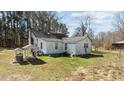 Rear exterior of the home showing the white siding and surrounding yard at 2710 Morton Pulliam Rd, Roxboro, NC 27574