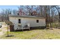 Backyard view of a cozy home with a small deck at 2778 Morton-Pulliam Rd, Roxboro, NC 27574