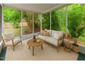 Bright sunroom with comfortable seating, neutral decor, and views of the landscaped backyard at 3405 E Jameson Rd, Raleigh, NC 27604