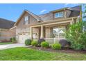Attractive two-story home with a welcoming front porch and beautifully landscaped front yard at 4110 Argyle Trl, Burlington, NC 27215