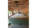 Unfinished living room showcases open layout, fireplace, exposed ceiling beams, and glass doors leading to the outdoors at 432 Golden Dragonfly St, Wake Forest, NC 27587
