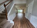Inviting entryway with wood-look flooring and a staircase leading to the upper level of the home at 4903 Bridgewood Dr, Durham, NC 27713