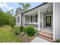 Inviting front porch with comfortable seating and lush landscaping, perfect for relaxing outdoors at 50 Harriet Gentry Ln, Timberlake, NC 27583