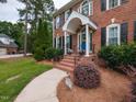 Charming front entrance with brick steps and wrought iron railings at 5009 Beckwyck Dr, Fuquay Varina, NC 27526