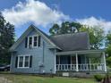 Two story home with porch, vinyl siding and black shutters, and well maintained lawn at 509 W Rose St, Sanford, NC 27330