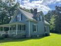 Side view of charming two-story house with green lawn at 509 W Rose St, Sanford, NC 27330