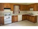 Functional kitchen with wood cabinets, white appliances, and plenty of counter space at 509 W Rose St, Sanford, NC 27330